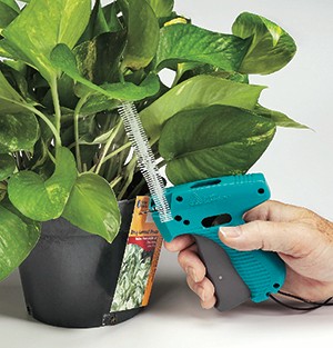 Horticultural Tool attaching tag to potted plant